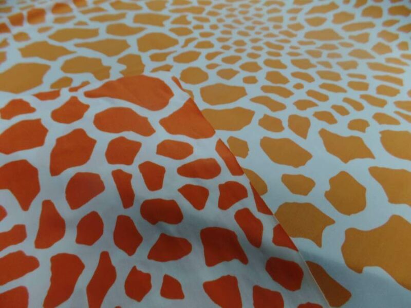 lycra double face imprime girafe ton orange et blanc Lycra double face imprimé girafe orange blanc